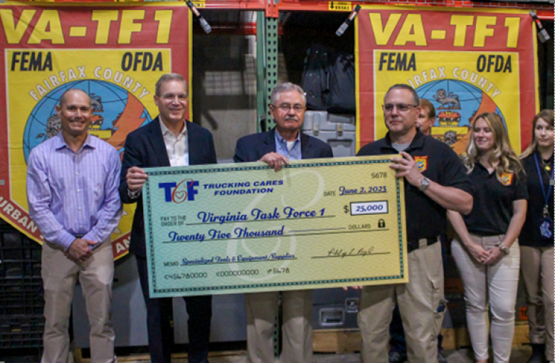 Trucking Cares Foundation Chairman Phil Byrd, with ATA President and CEO Chris Spear and TCF President John Lynch present a check for $25,000 to Battalion Chief Jeff Lewis of Virginia Task Force-1.